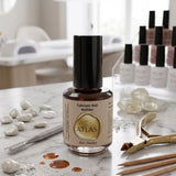 Flacon de soin Atlas Calcium Nail Builder 15ml, illustré dans le fichier Atlas-Calcium-Nail-Builder-15ml.webp, présenté sur une table de travail en marbre avec des accessoires professionnels d'onglerie.