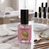 Flacon de Cuticle Remover ATLAS 15ml, présenté sur une table de travail en marbre avec des outils professionnels d'onglerie.